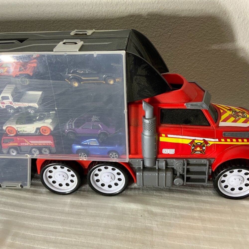 Red Toy truck, carrying 8 small multicolored cars